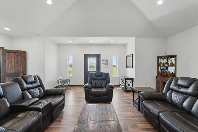 a living room with furniture and wooden floor