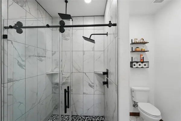 a bathroom with a shower and toilet