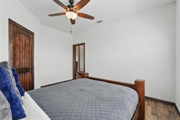 a view of a livingroom with a ceiling fan and wooden floor