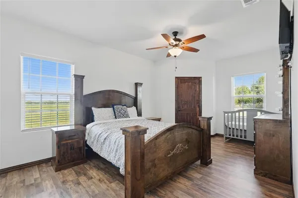 a bedroom with a bed and a window