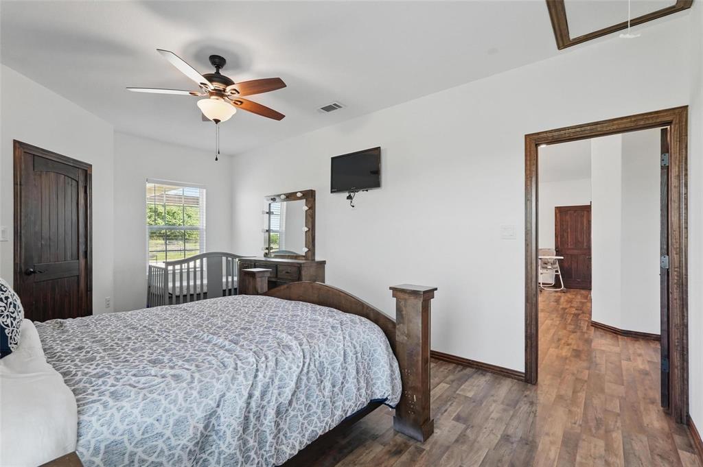4248 North Fm 273 Ivanhoe, TX 75447 - Photo 25 of 33 a bedroom with a bed and a chandelier