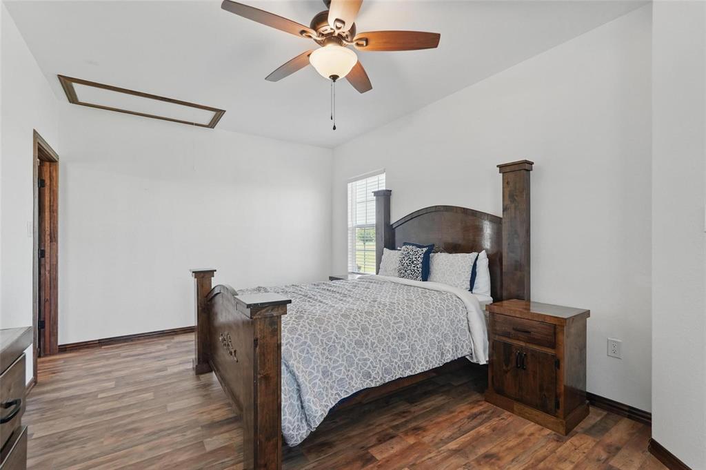 4248 North Fm 273 Ivanhoe, TX 75447 - Photo 26 of 33 a bedroom with a bed and a chandelier
