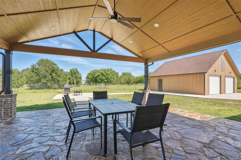 4248 North Fm 273 Ivanhoe, TX 75447 - Photo 28 of 33 a patio with a table and chairs and potted plants
