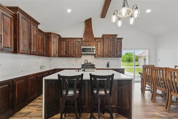 a view of a dining room with furniture wooden floor and chandelier
