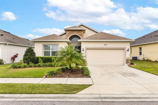 a front view of a house with a yard and garage