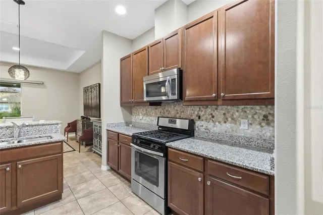 an aerial view of a house with a yard and lake