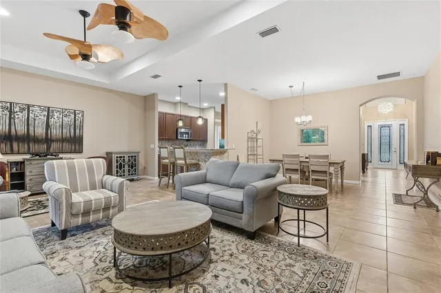 a view of a dining room with furniture and chandelier