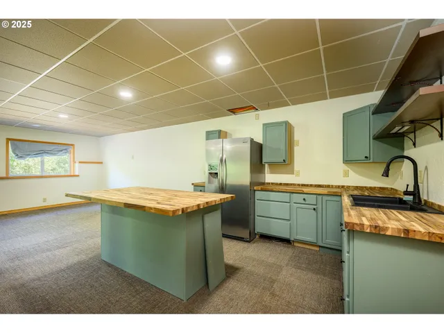 a view of a kitchen with a sink and cabinets