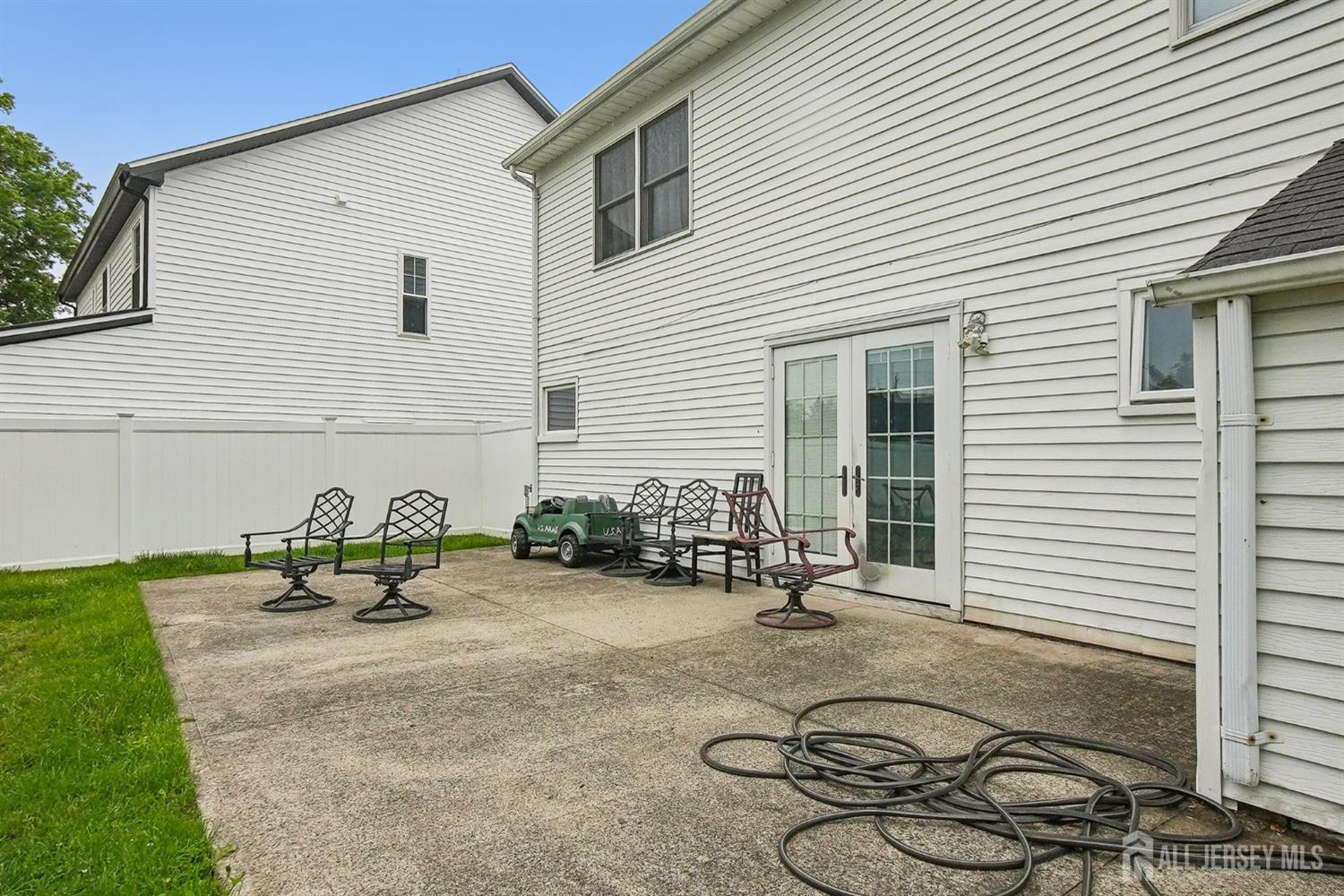 30 Kenmore Road Edison, NJ 08817 - Photo 23 of 25 a backyard of a house with table and chairs