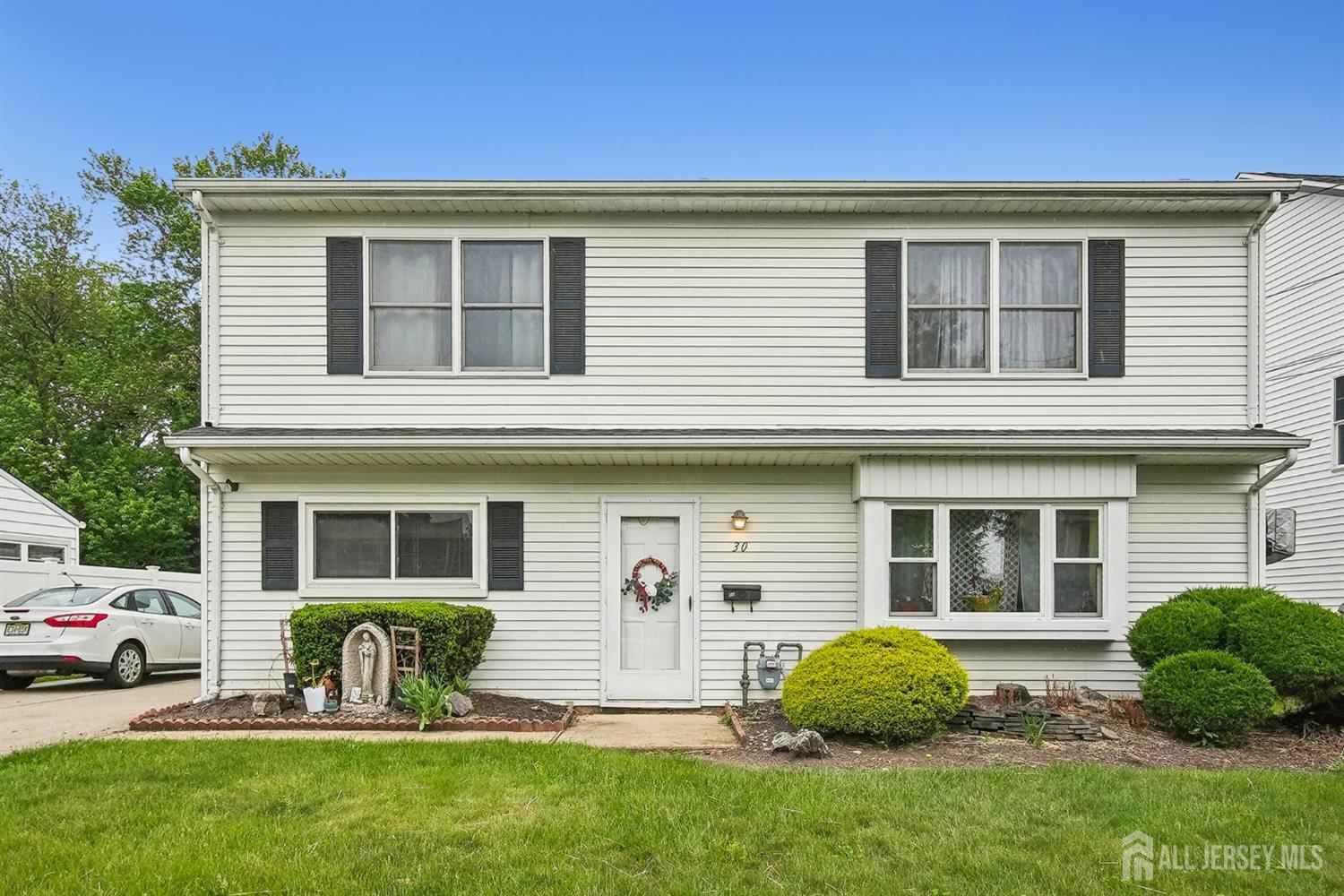 30 Kenmore Road Edison, NJ 08817 - Photo 3 of 25 a front view of a house with a garden