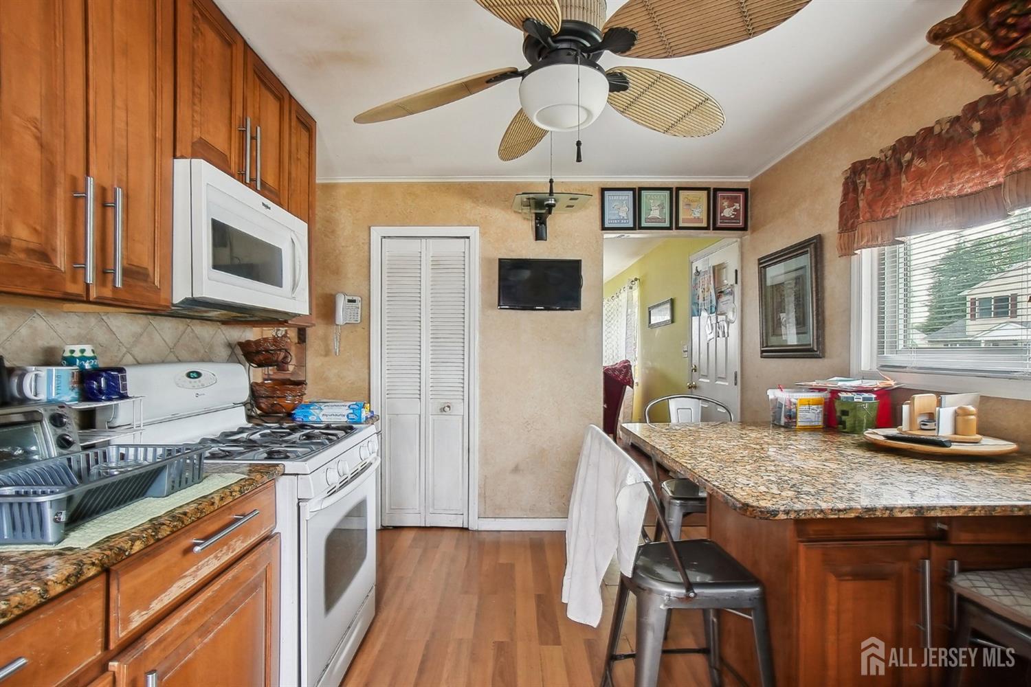 30 Kenmore Road Edison, NJ 08817 - Photo 5 of 25 a kitchen with granite countertop kitchen island stainless steel appliances a stove a sink a refrigerator cabinets and dining table