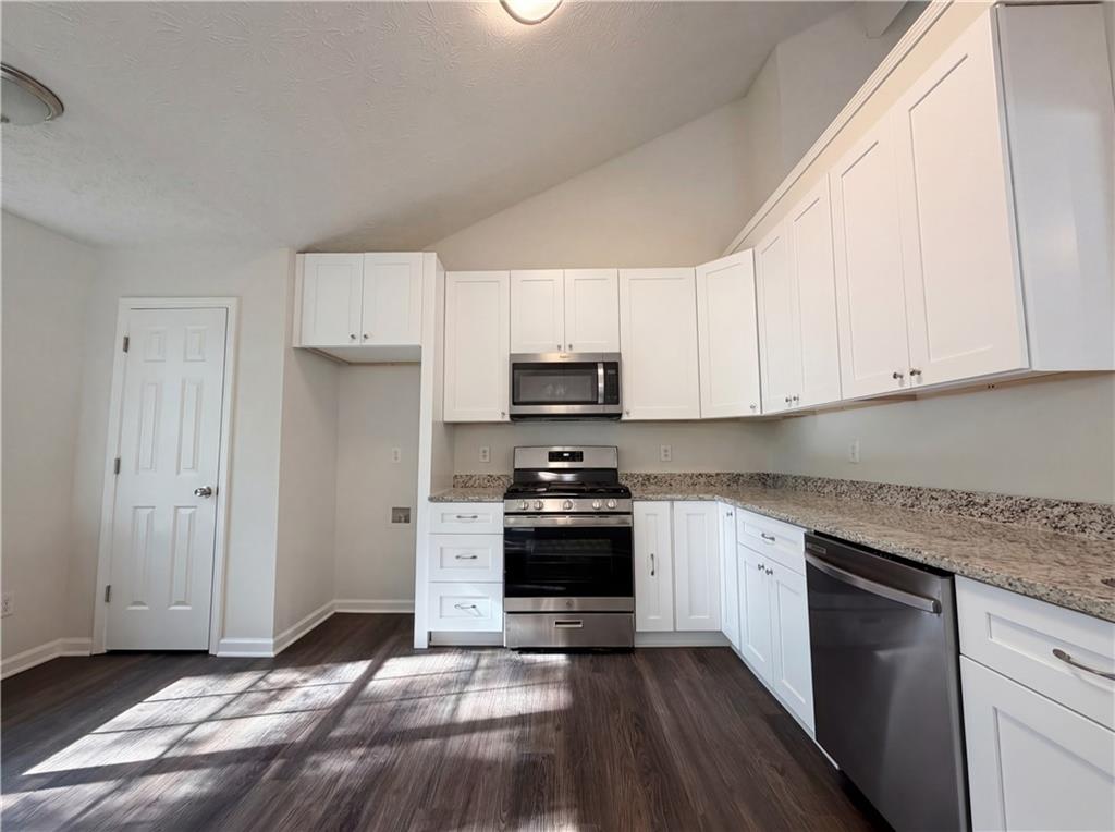 3546 Broad Oak Court Decatur, GA 30034 - Photo 22 of 33 a kitchen with granite countertop white cabinets and stainless steel appliances