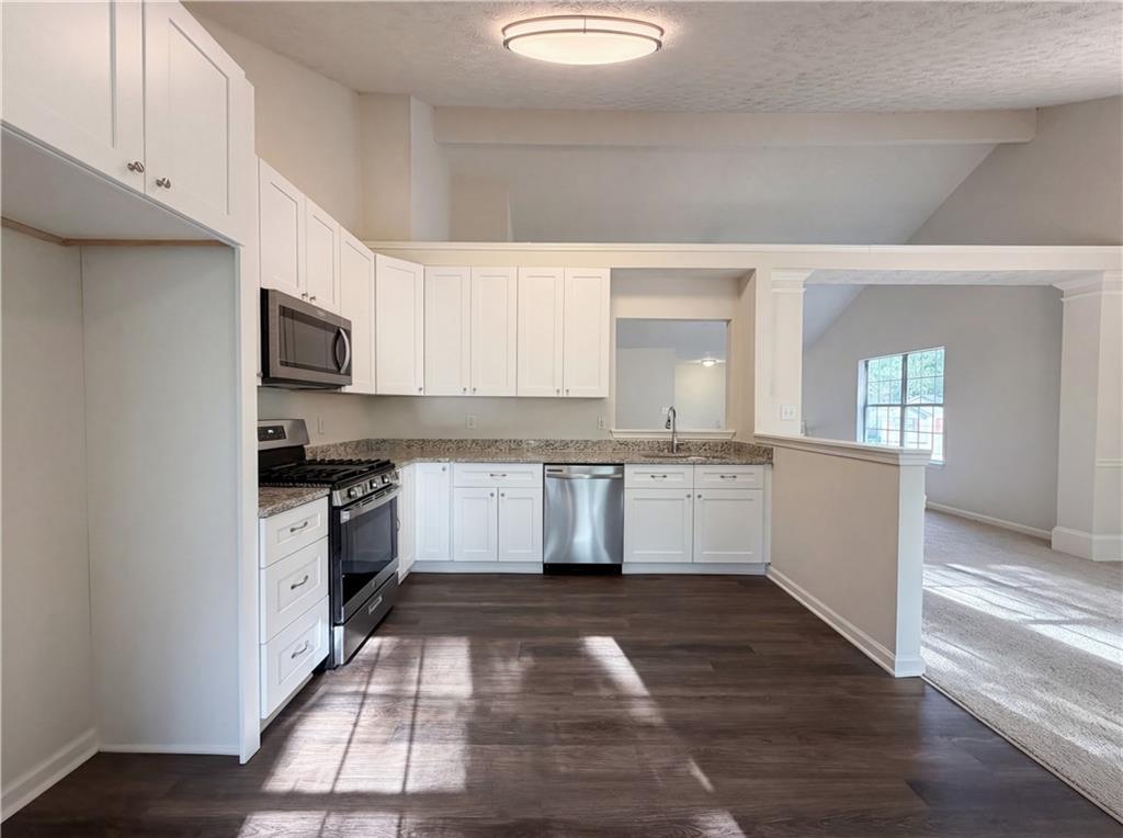 3546 Broad Oak Court Decatur, GA 30034 - Photo 23 of 33 a kitchen with granite countertop a stove top oven and cabinets