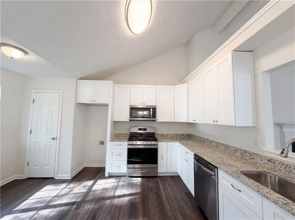 3546 Broad Oak Court Decatur, GA 30034 - Photo 25 of 33 a kitchen with granite countertop a refrigerator and a stove top oven