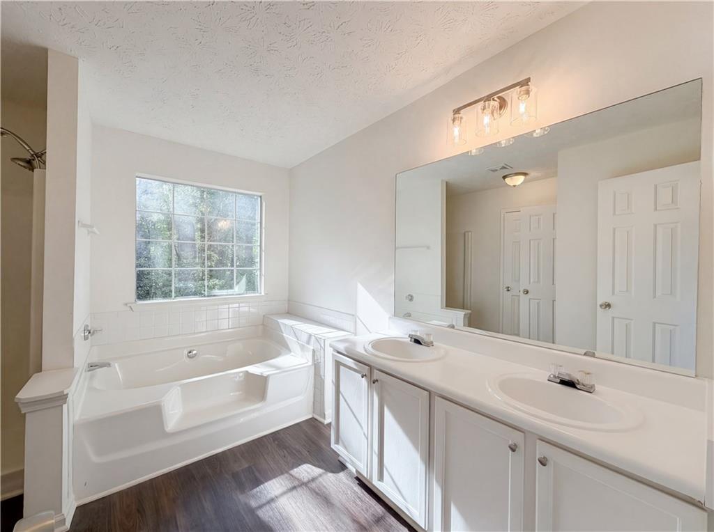 3546 Broad Oak Court Decatur, GA 30034 - Photo 6 of 33 a bathroom with a bathtub a double vanity sink a vanity a window and a bathtub