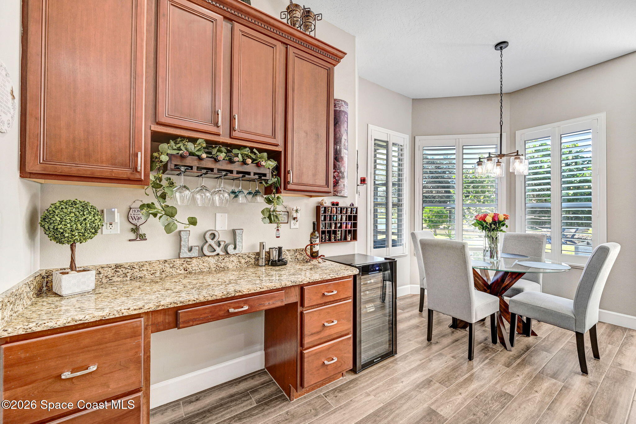 3330 Poseidon Way Indialantic, FL 32903 - Photo 12 of 47 a kitchen with stainless steel appliances granite countertop sink stove and white cabinets with wooden floor