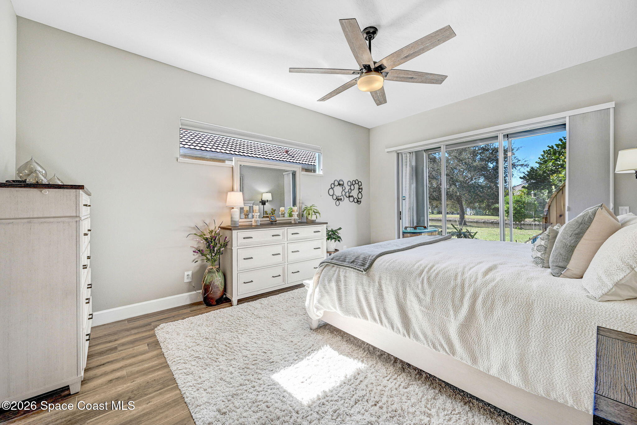 3330 Poseidon Way Indialantic, FL 32903 - Photo 20 of 47 a bedroom with a large bed and a chandelier