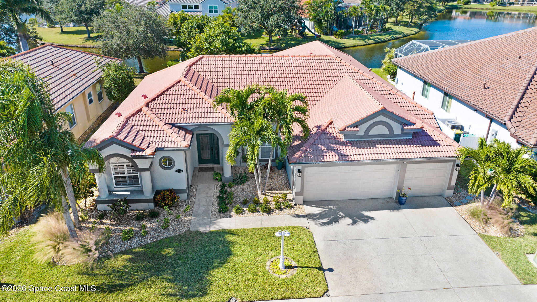 3330 Poseidon Way Indialantic, FL 32903 - Photo 3 of 47 a front view of house with yard and swimming pool