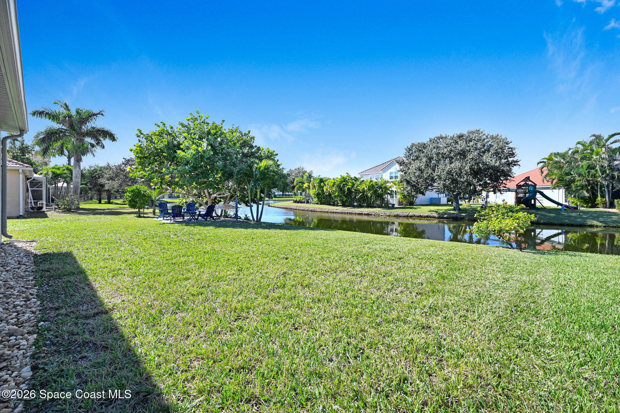 3330 Poseidon Way Indialantic, FL 32903 - Photo 37 of 47 a view of a garden with a building in the background