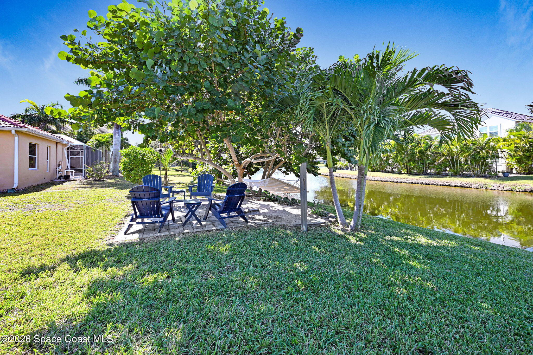 3330 Poseidon Way Indialantic, FL 32903 - Photo 38 of 47 a view of backyard with swimming pool and bench