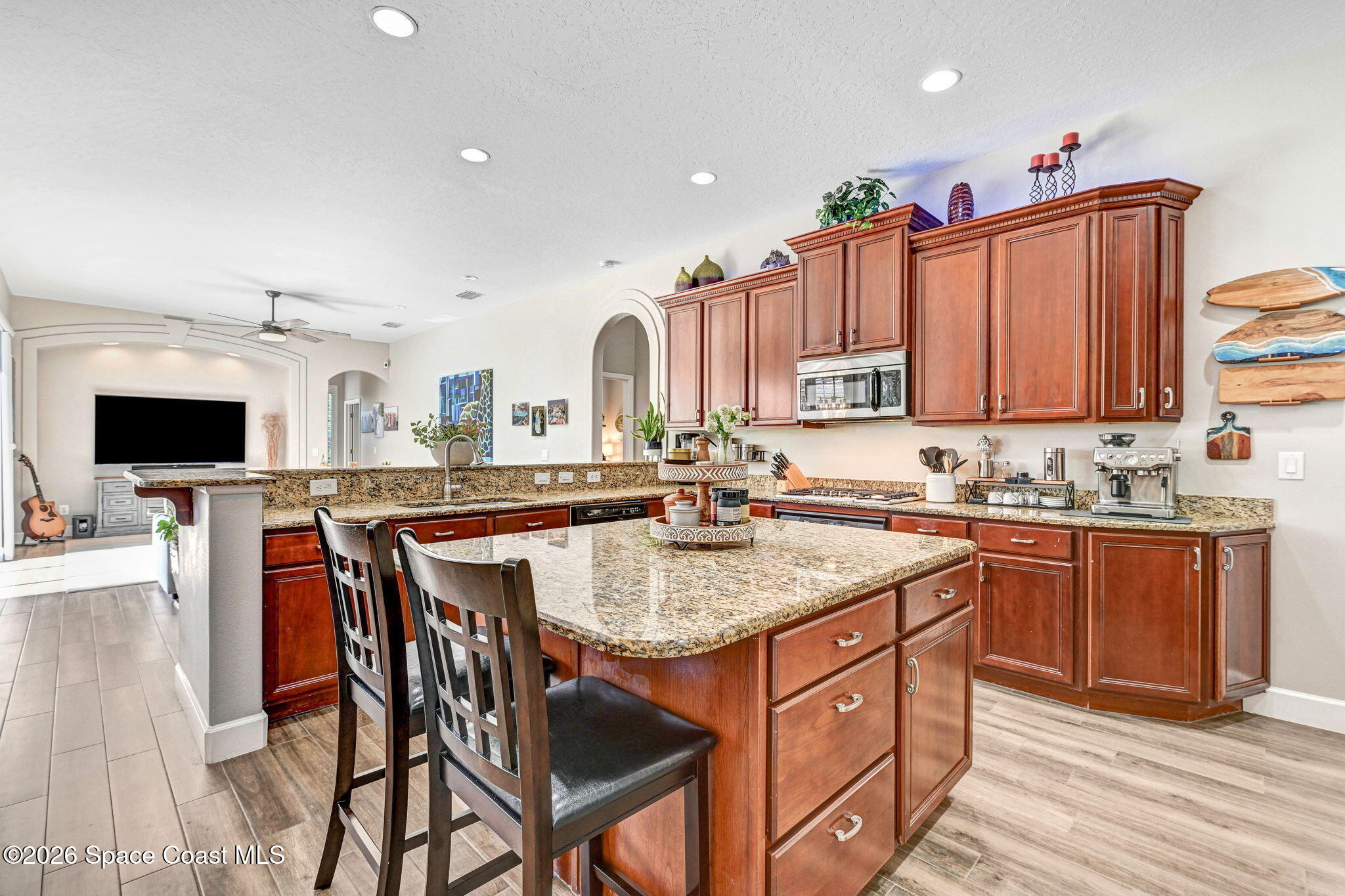 3330 Poseidon Way Indialantic, FL 32903 - Photo 8 of 47 a kitchen with stainless steel appliances granite countertop a kitchen island a stove a table and chairs