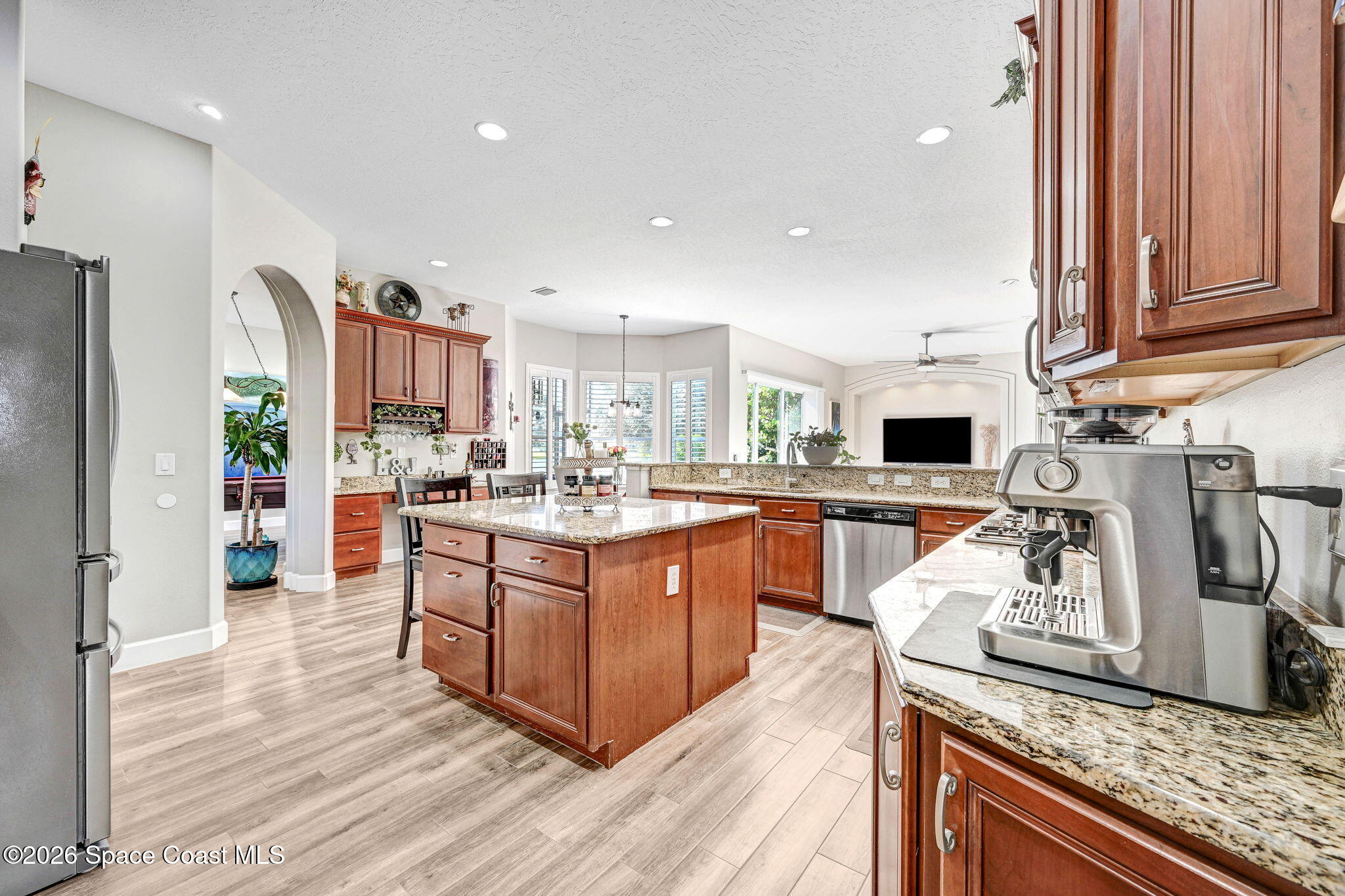 3330 Poseidon Way Indialantic, FL 32903 - Photo 10 of 47 a kitchen with stainless steel appliances granite countertop a sink stove and refrigerator