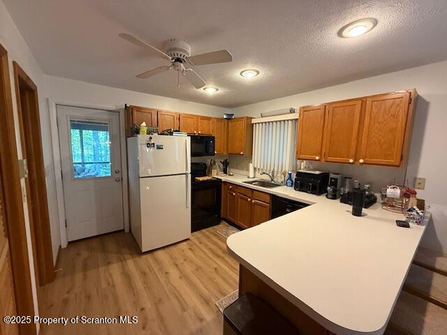 126 Dunchurch Drive Bushkill, PA 18324 - Photo 23 of 26 a kitchen with sink a refrigerator and wooden cabinets