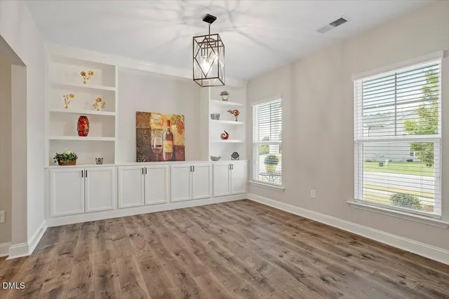 a view of staircase with wooden floor and fan