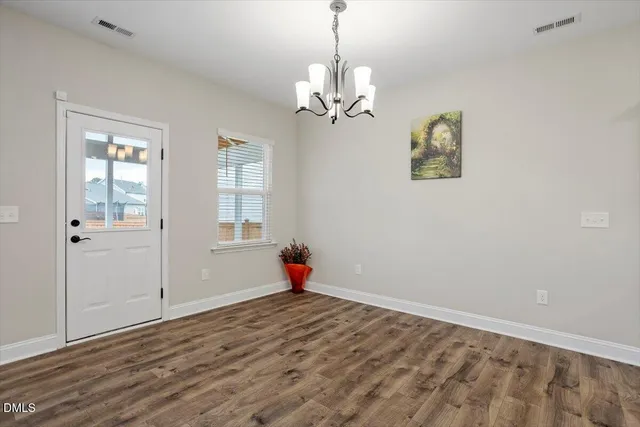 a view of an empty room with window and fireplace