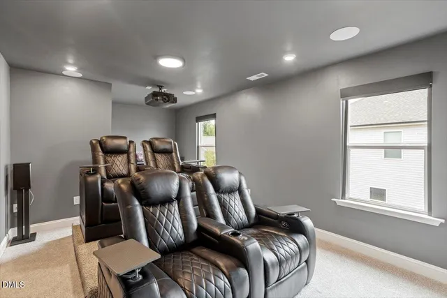 a view of a white building with a yard in front of it