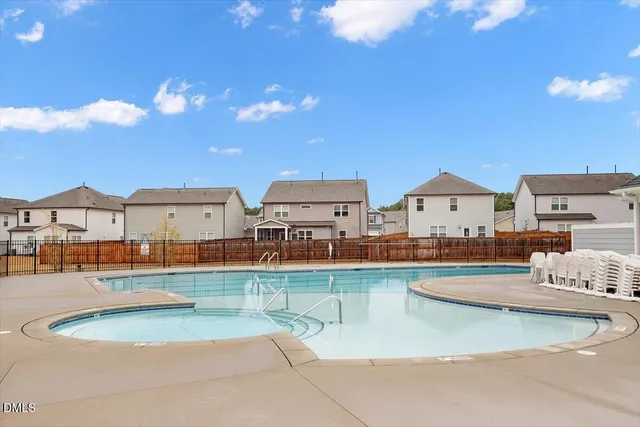 a living room with fireplace furniture and a large window