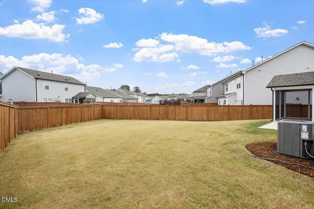 a view of a house with a yard and a porch