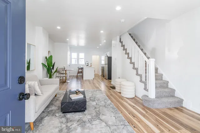 a living room with furniture and a potted plant