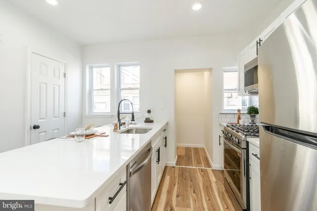 a kitchen with a sink stove and refrigerator