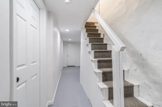 a view of a hallway with wooden floor and entryway