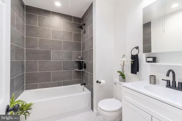 a bathroom with a bathtub a sink a toilet and a mirror