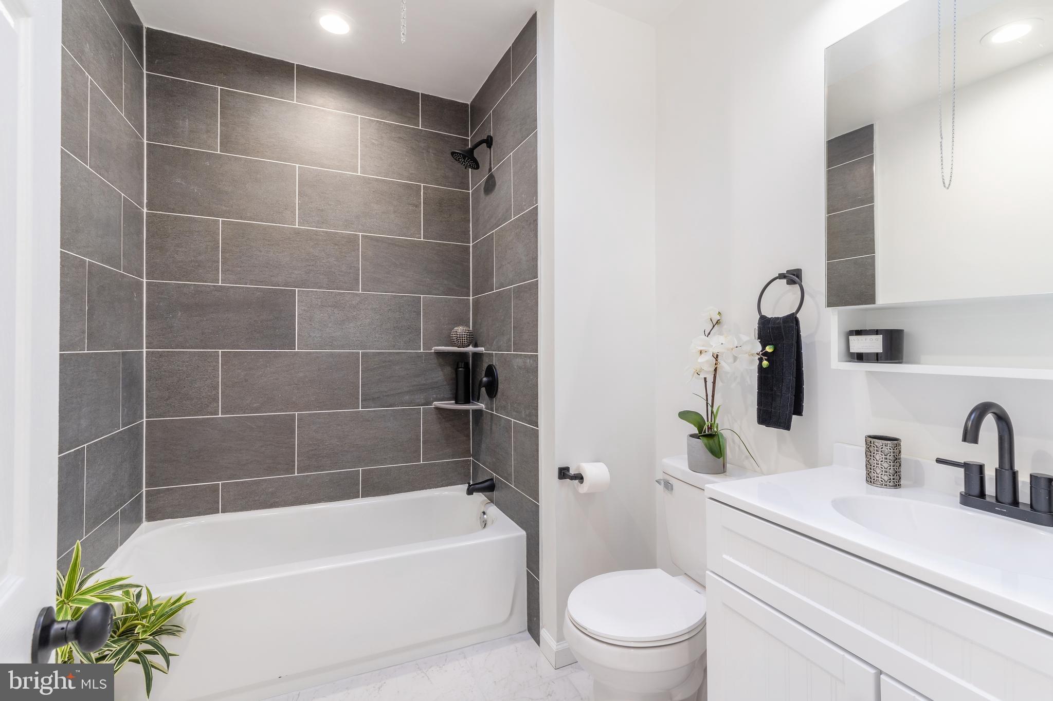 3312 North Bailey Street Philadelphia, PA 19129 - Photo 21 of 35 a bathroom with a bathtub a sink a toilet and a mirror