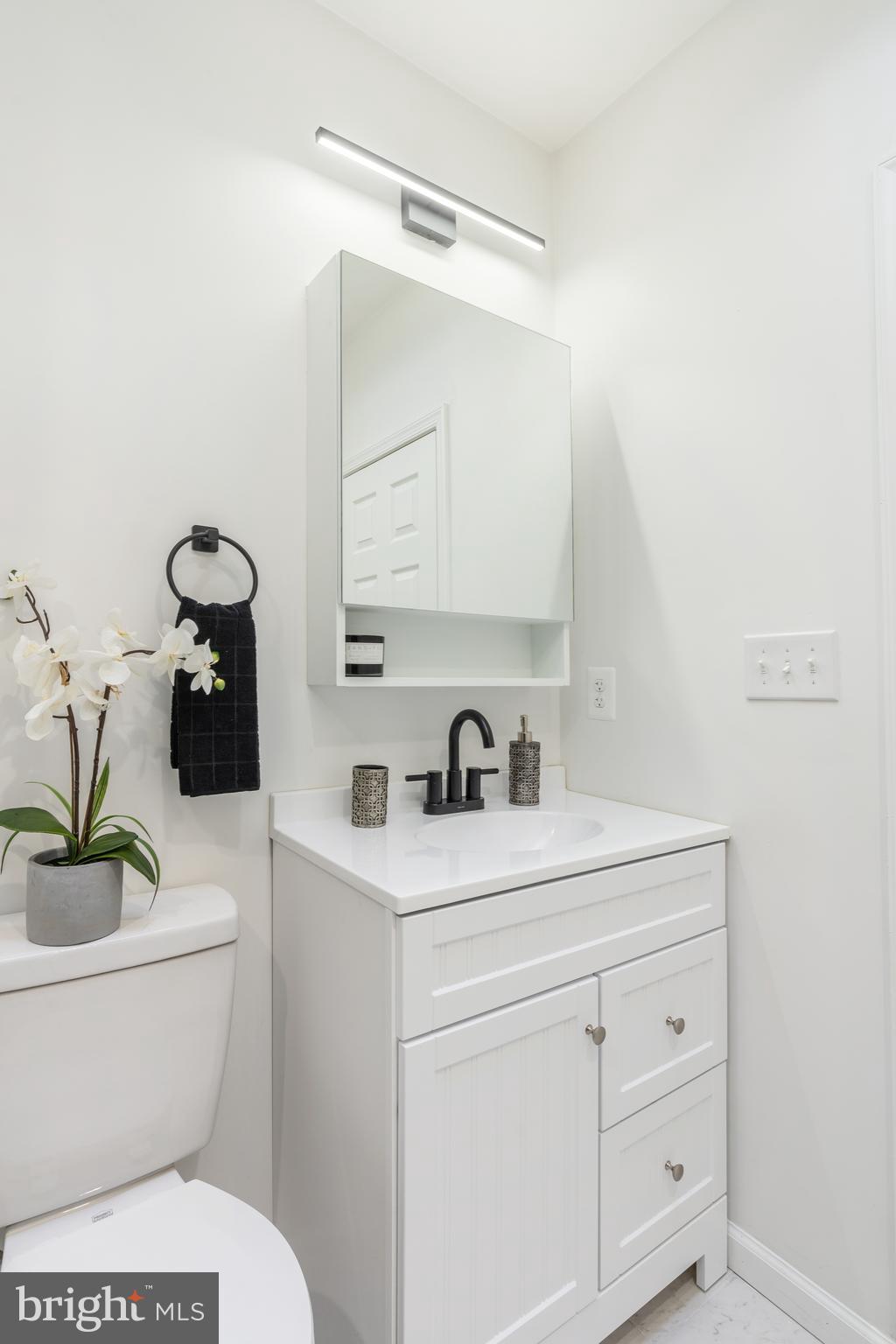 3312 North Bailey Street Philadelphia, PA 19129 - Photo 24 of 35 a bathroom with a granite countertop toilet sink and mirror