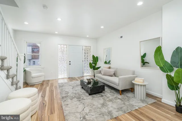 a living room with furniture potted plant and a toilet