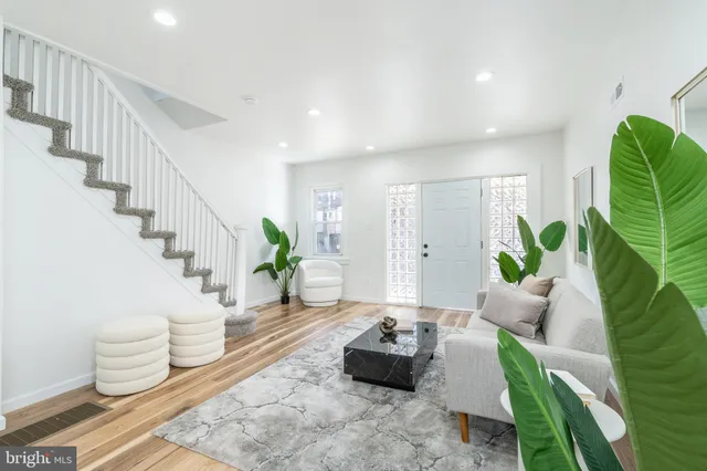 a living room with furniture and a potted plant