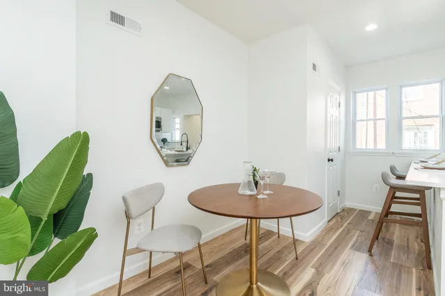 a dining room with furniture and a mirror