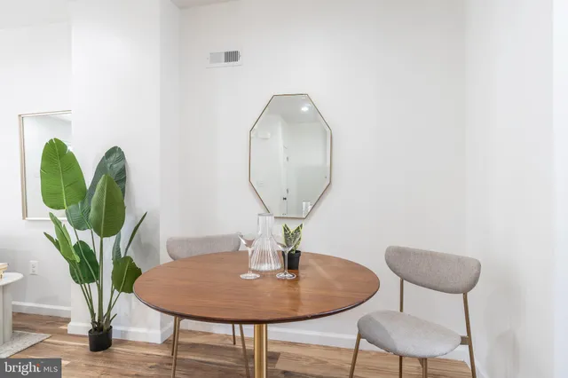 a view of a room with a table and chairs