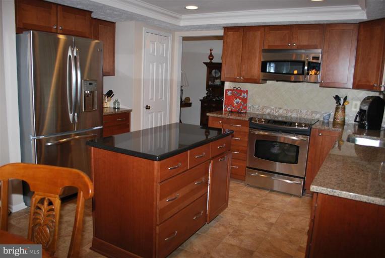 7837 Roundabout Way Springfield, VA 22153 - Photo 2 of 24 a kitchen with stainless steel appliances granite countertop a granite counter tops and a refrigerator