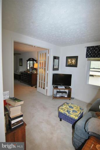 7837 Roundabout Way Springfield, VA 22153 - Photo 14 of 24 a living room with furniture and a flat screen tv