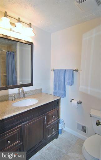 7837 Roundabout Way Springfield, VA 22153 - Photo 19 of 24 a bathroom with a sink a toilet and mirror