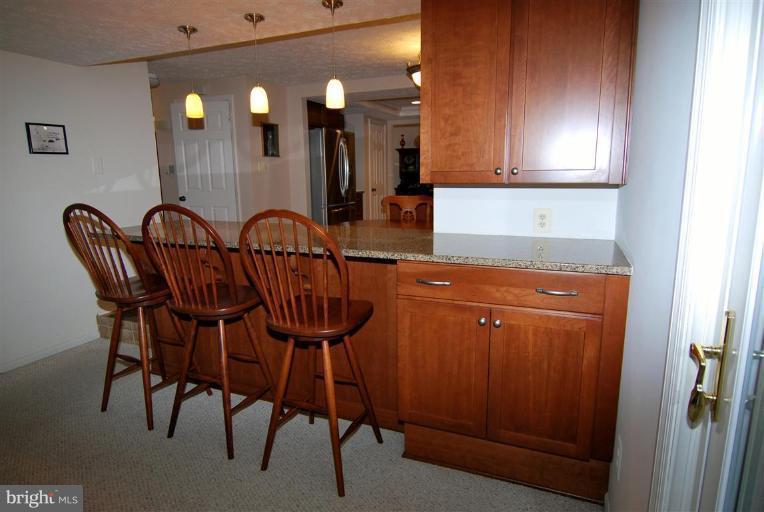 7837 Roundabout Way Springfield, VA 22153 - Photo 4 of 24 a kitchen with a table chairs and entryway