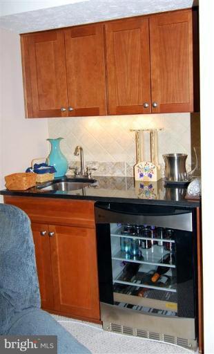 7837 Roundabout Way Springfield, VA 22153 - Photo 6 of 24 a kitchen with stainless steel appliances granite countertop a sink and cabinets