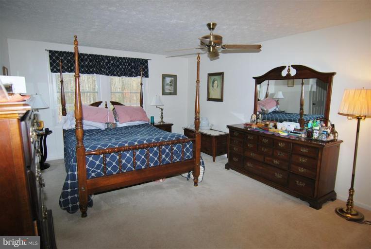 7837 Roundabout Way Springfield, VA 22153 - Photo 7 of 24 a bedroom with a bed and a dresser