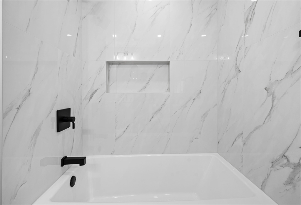 69 Readville Street, Unit B Boston, MA 02136 - Photo 12 of 38 a bathroom with a bathtub