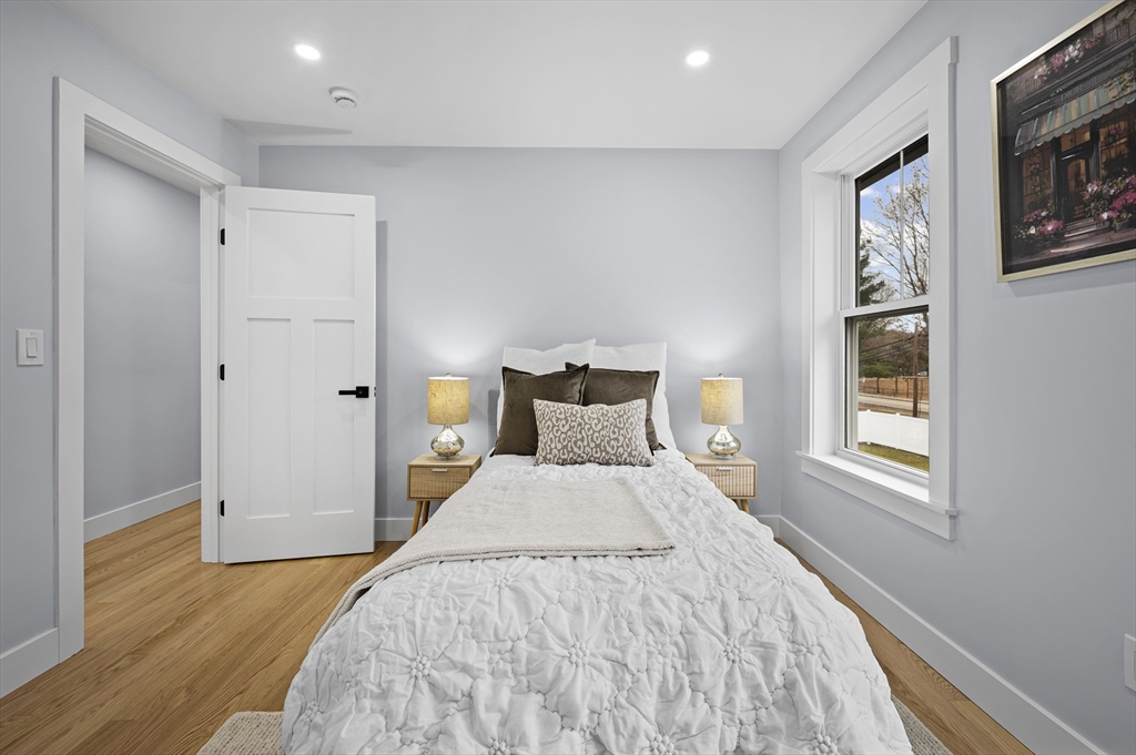 69 Readville Street, Unit B Boston, MA 02136 - Photo 15 of 38 a bedroom with a bed and wooden floor